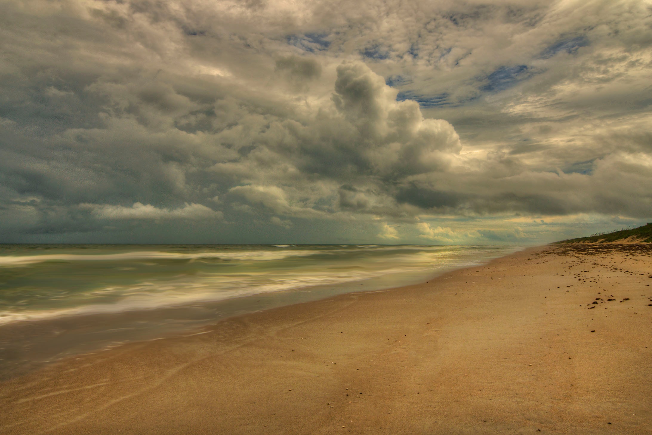 Dramatic storm clouds building over an empty Atlantic beach