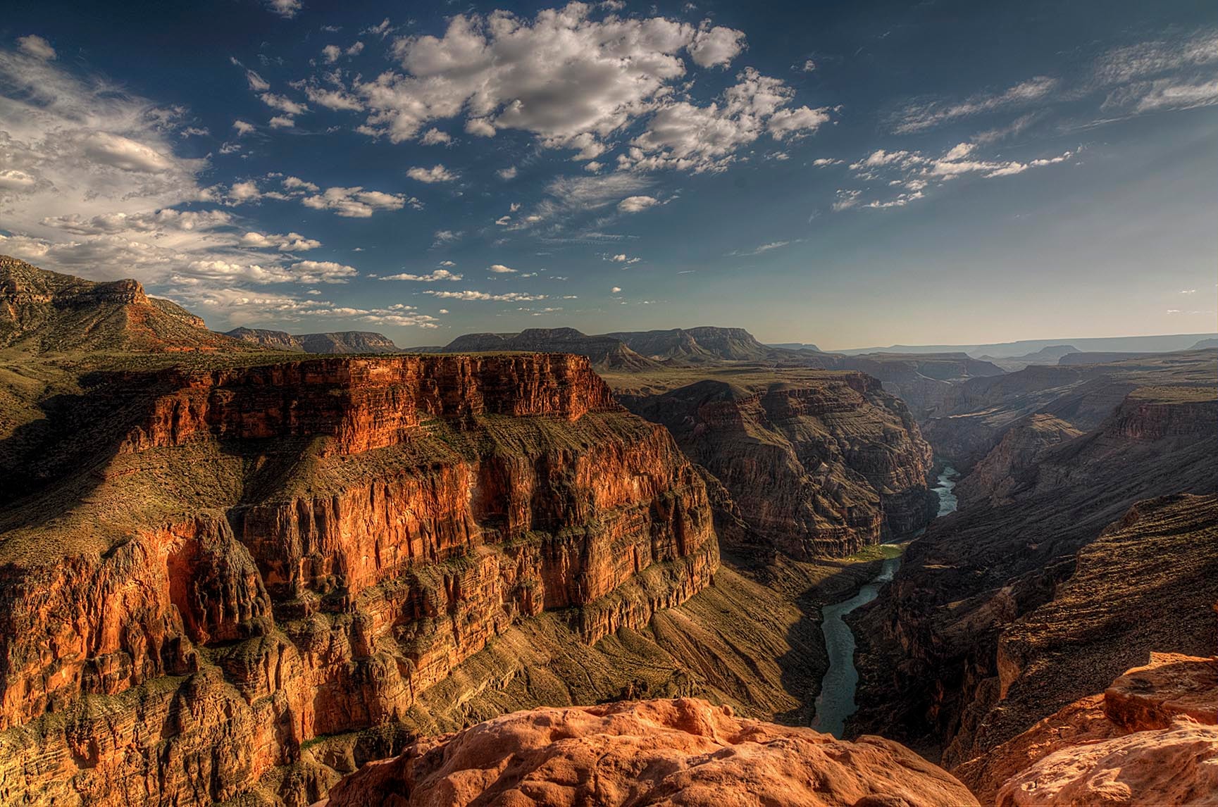Late afternoon at Toroweap, the Grand Canyon bathed in warm golden light as shadows deepen in the inner gorge far below