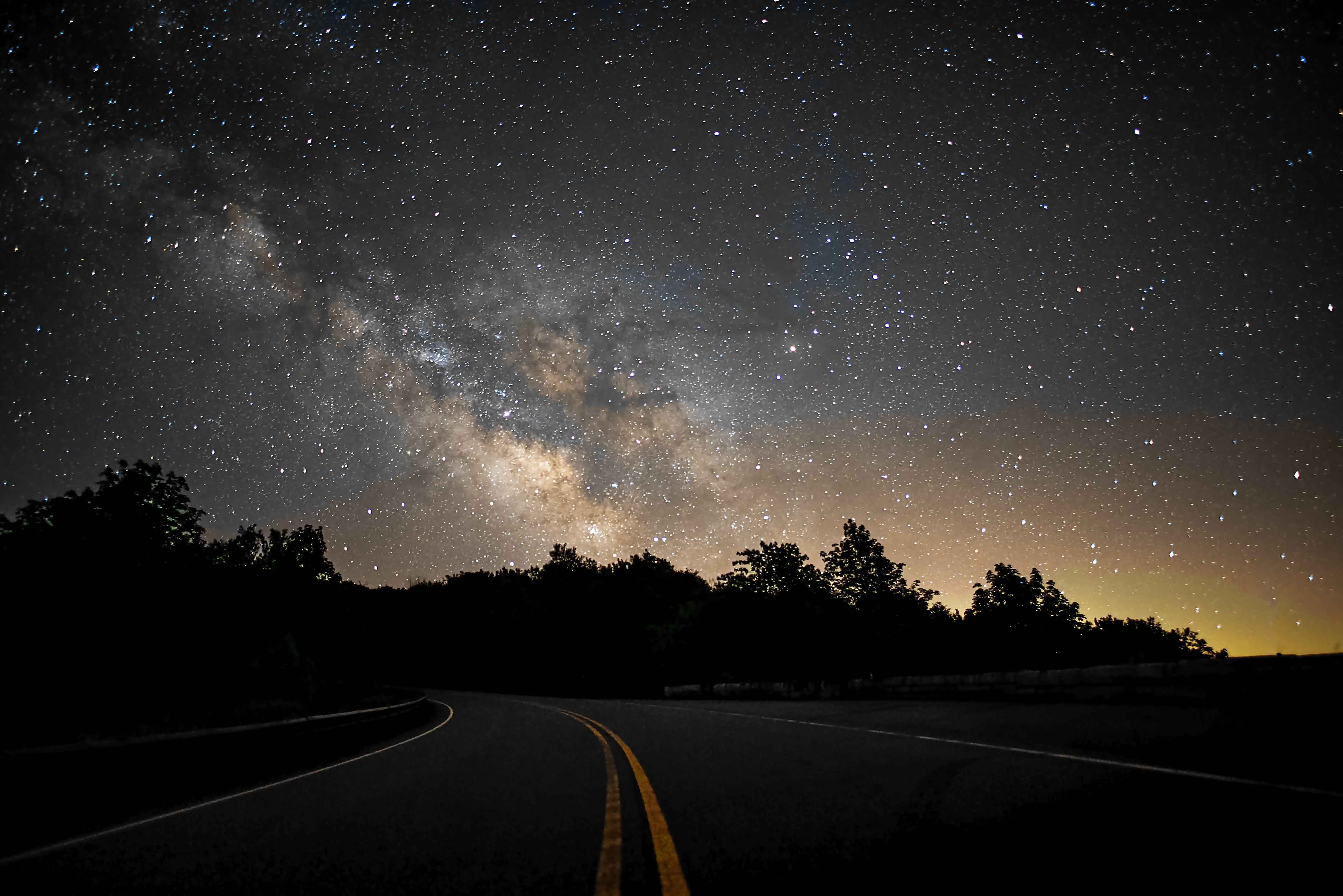 Milky Way over a winding road through the Cherohala Skyway forest