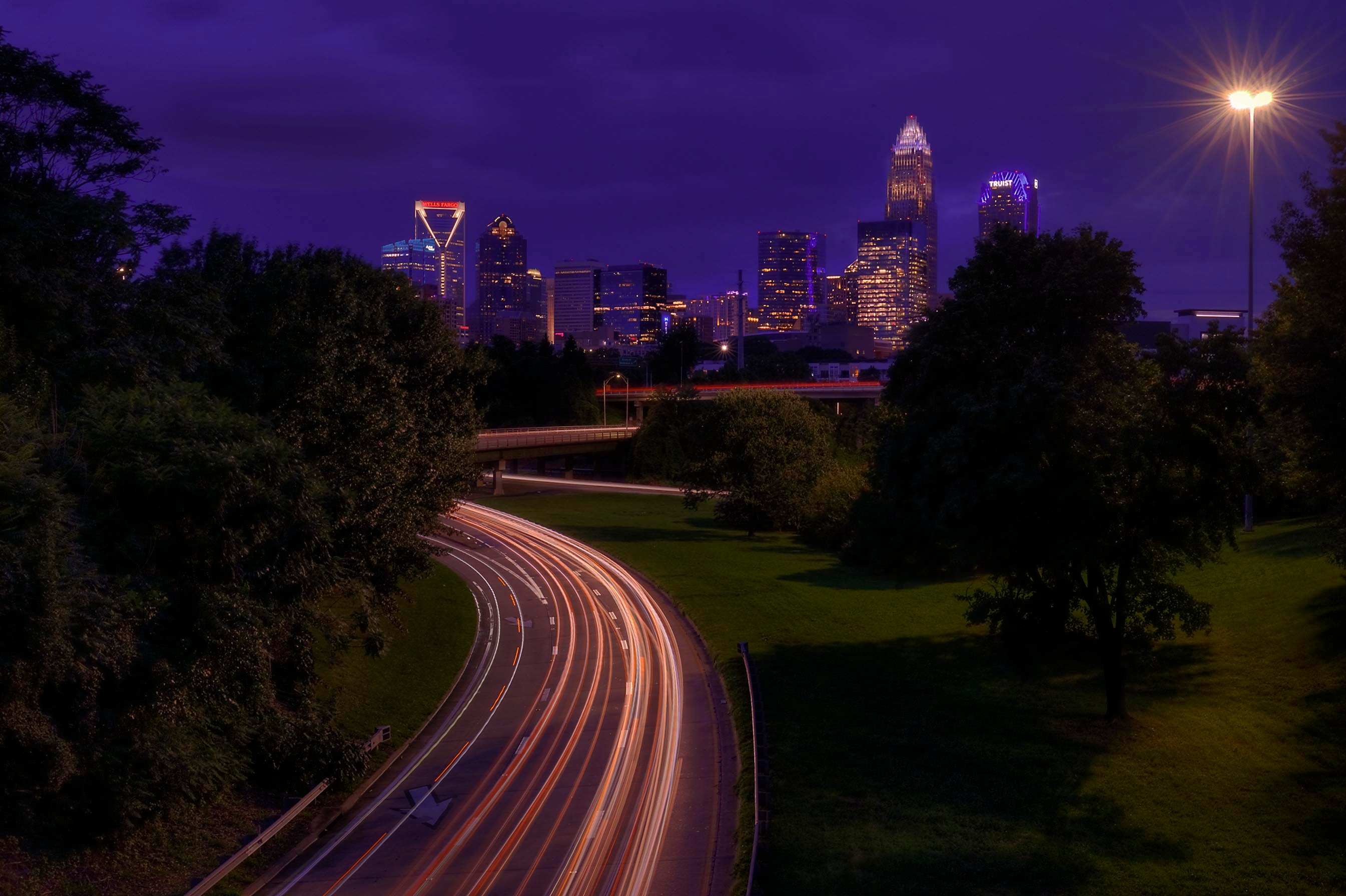 Charlotte NC skyline with highway light trails at dusk