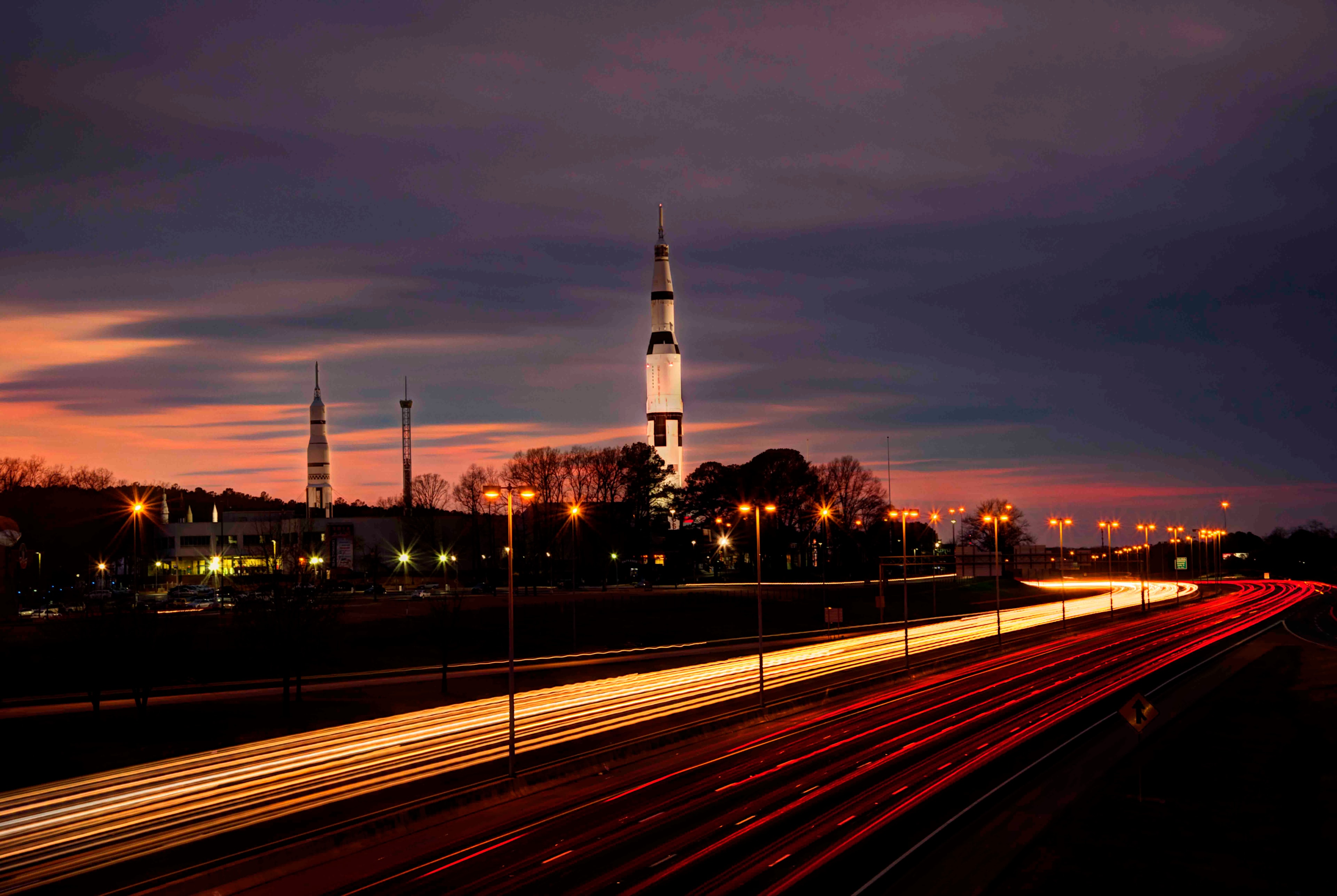 Huntsville rockets at dusk with sweeping highway light trails